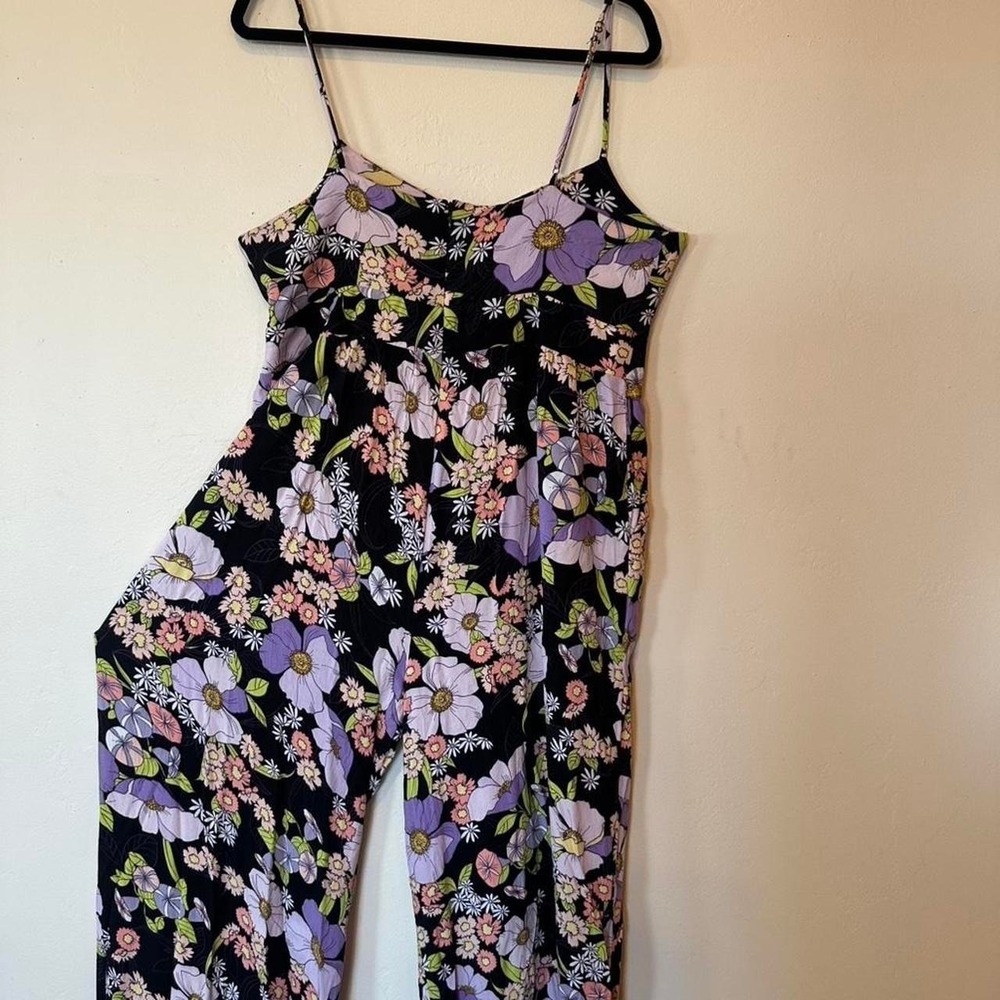 Afrm black floral jumpsuit with tie front and adjustable straps. Size: XL